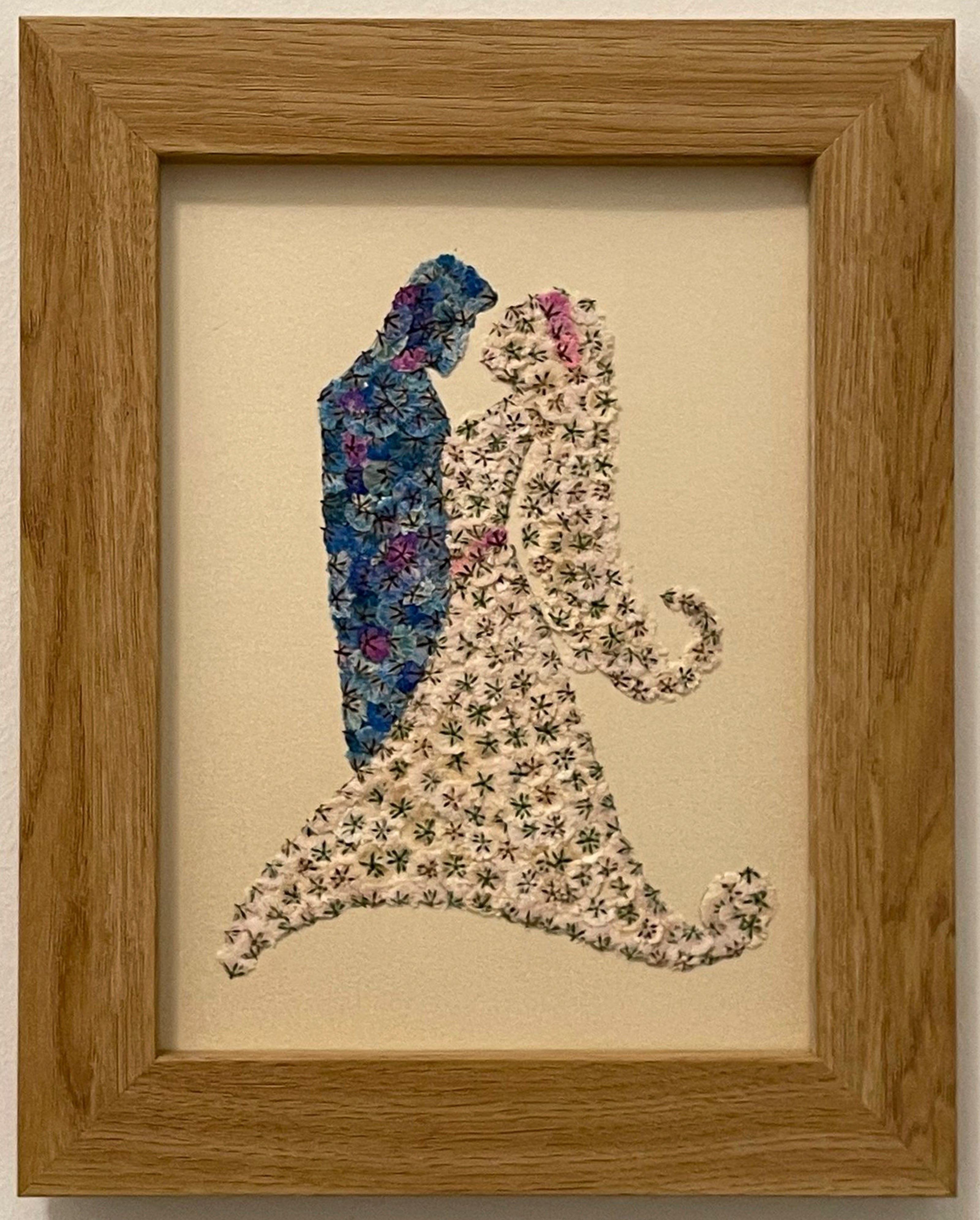 Pressed flower of bride in white and groom in blue